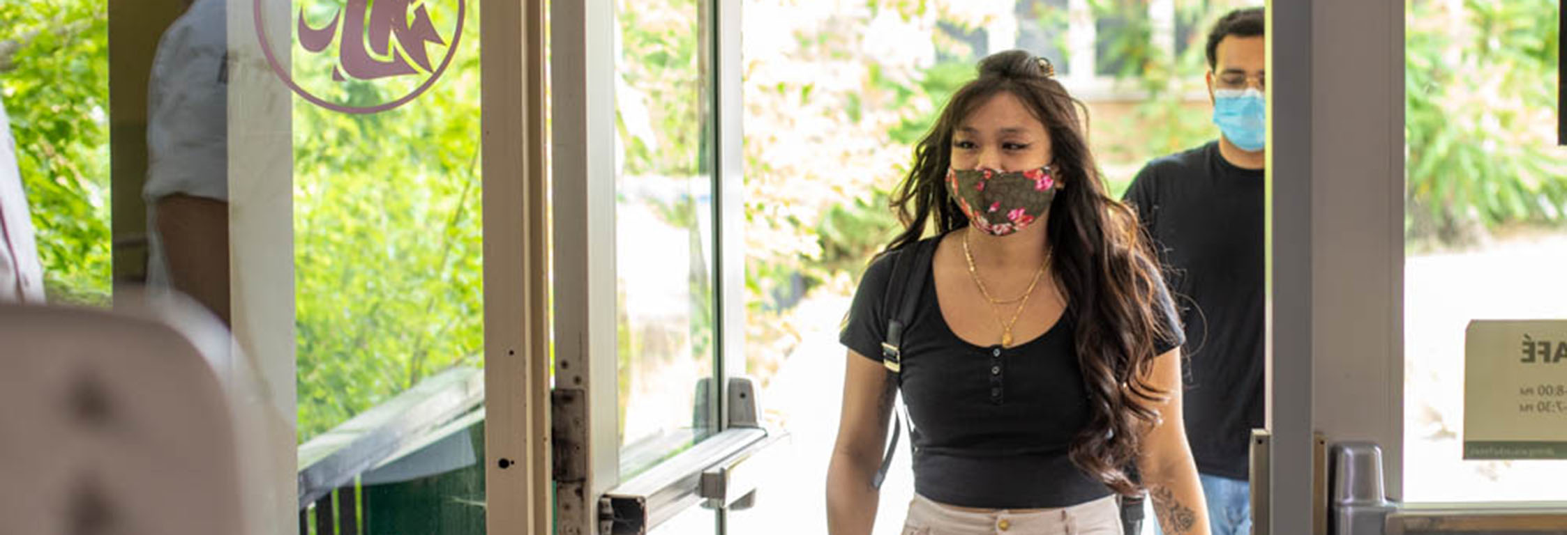 A student wearing a mask enters Southside Cafe.