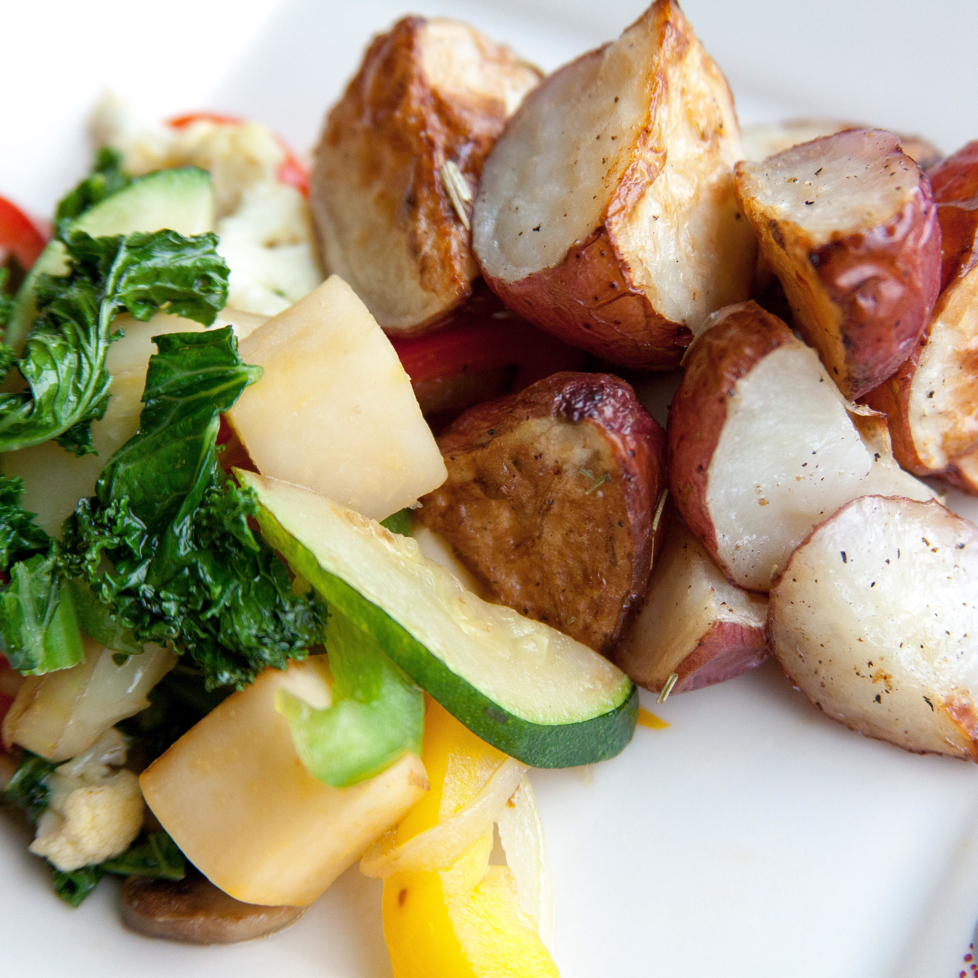 Cooked veggies and potatoes on a plate.