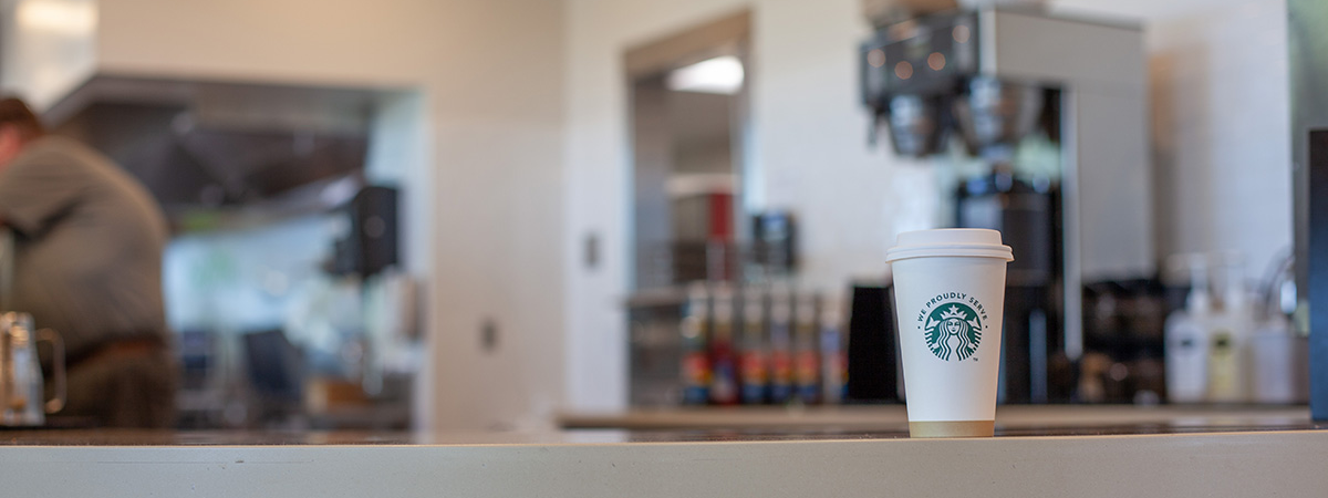 A Starbucks cup on a counter.
